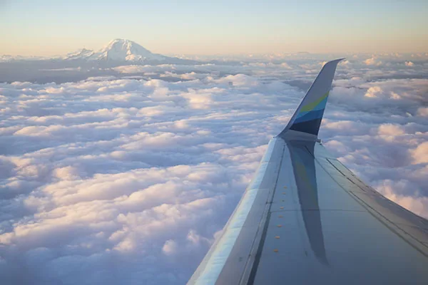 View over the wing above the clouds