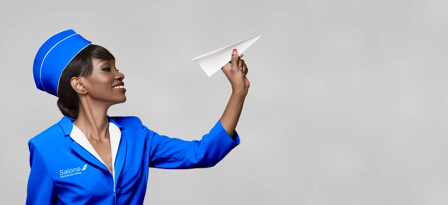 Salone International Airlines cabin crew member holding a paper aircraft