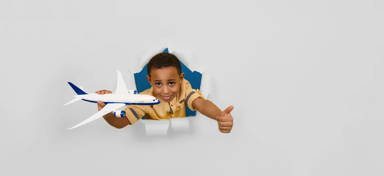 Child holding a model aircraft